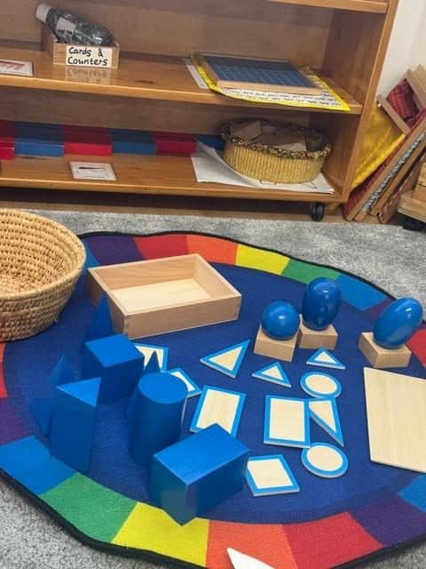 Montessori learning materials on classroom floor at northolt