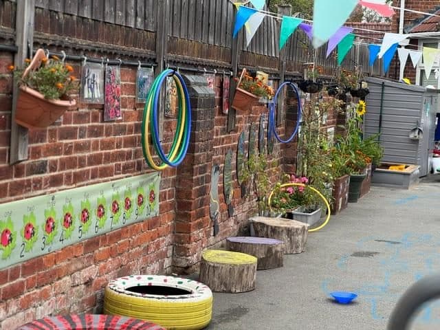 Outdoor play area with tyres at unique child montessori northolt
