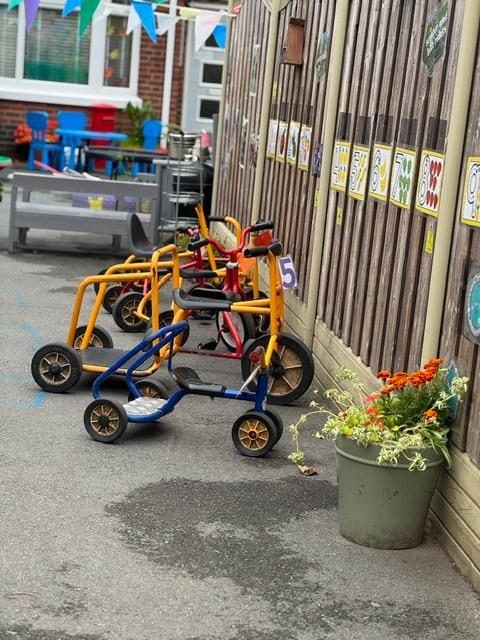 Tricycles and outdoor play area at unique child montessori northolt