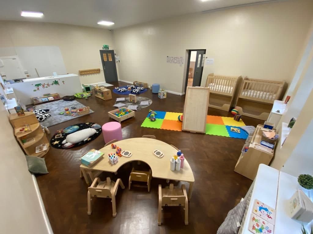 Activity table and play areas at Unique Child Montessori Stockwell